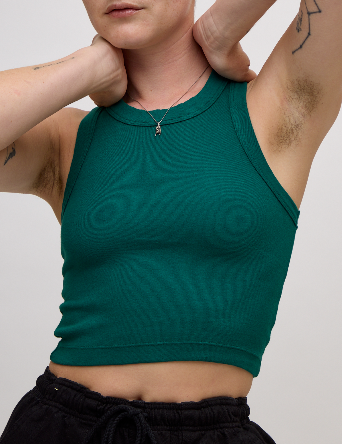Close up of Alex wearing the Hunter Green Deep Cut Racerback