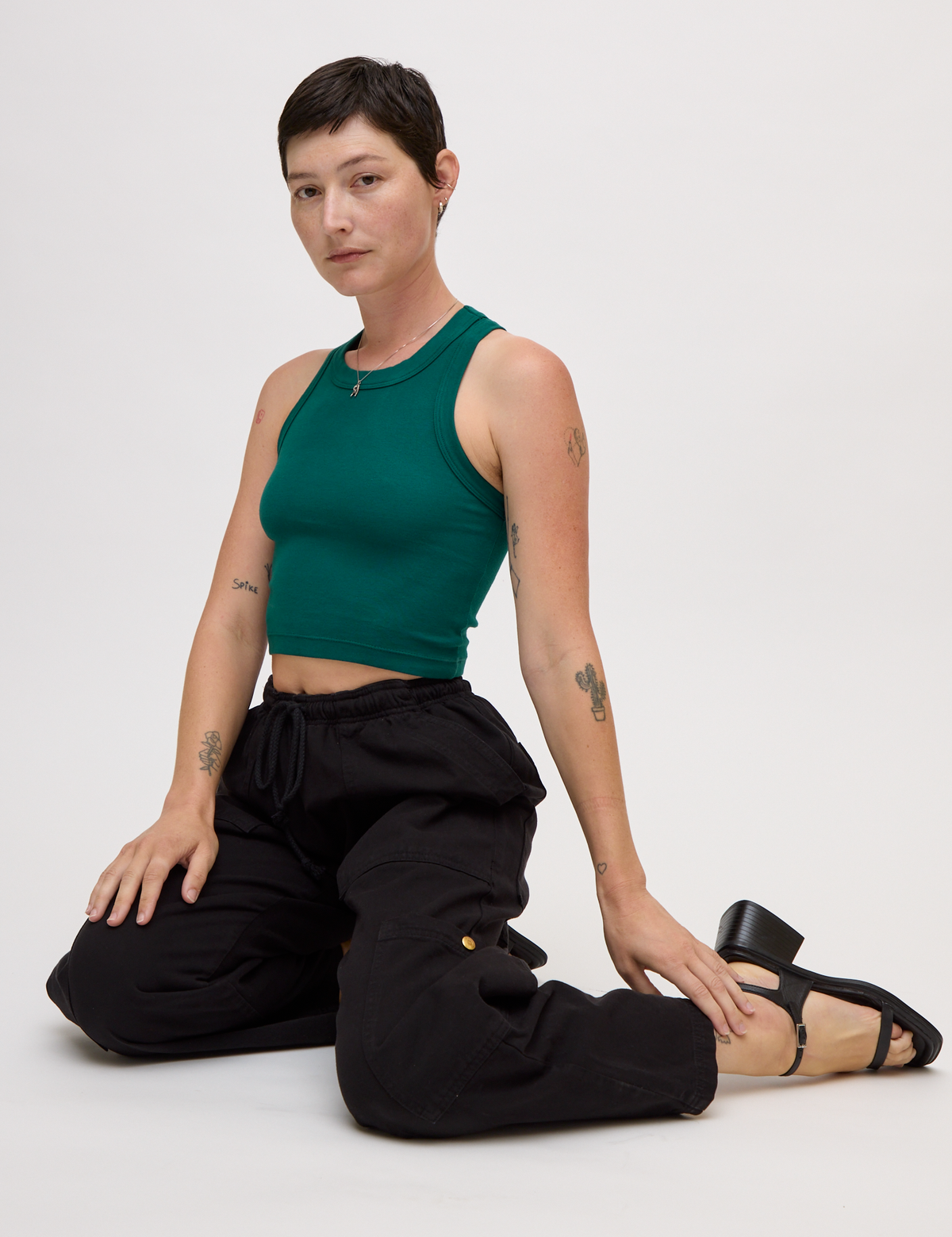 Alex wearing the Hunter Green Deep Cut Racerback with Black Drop Pocket Pants
