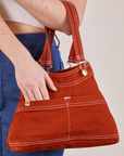 Overall Handbags in Paprika worn on arm of model