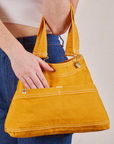 Overall Handbag in Mustard Yellow on arm of model