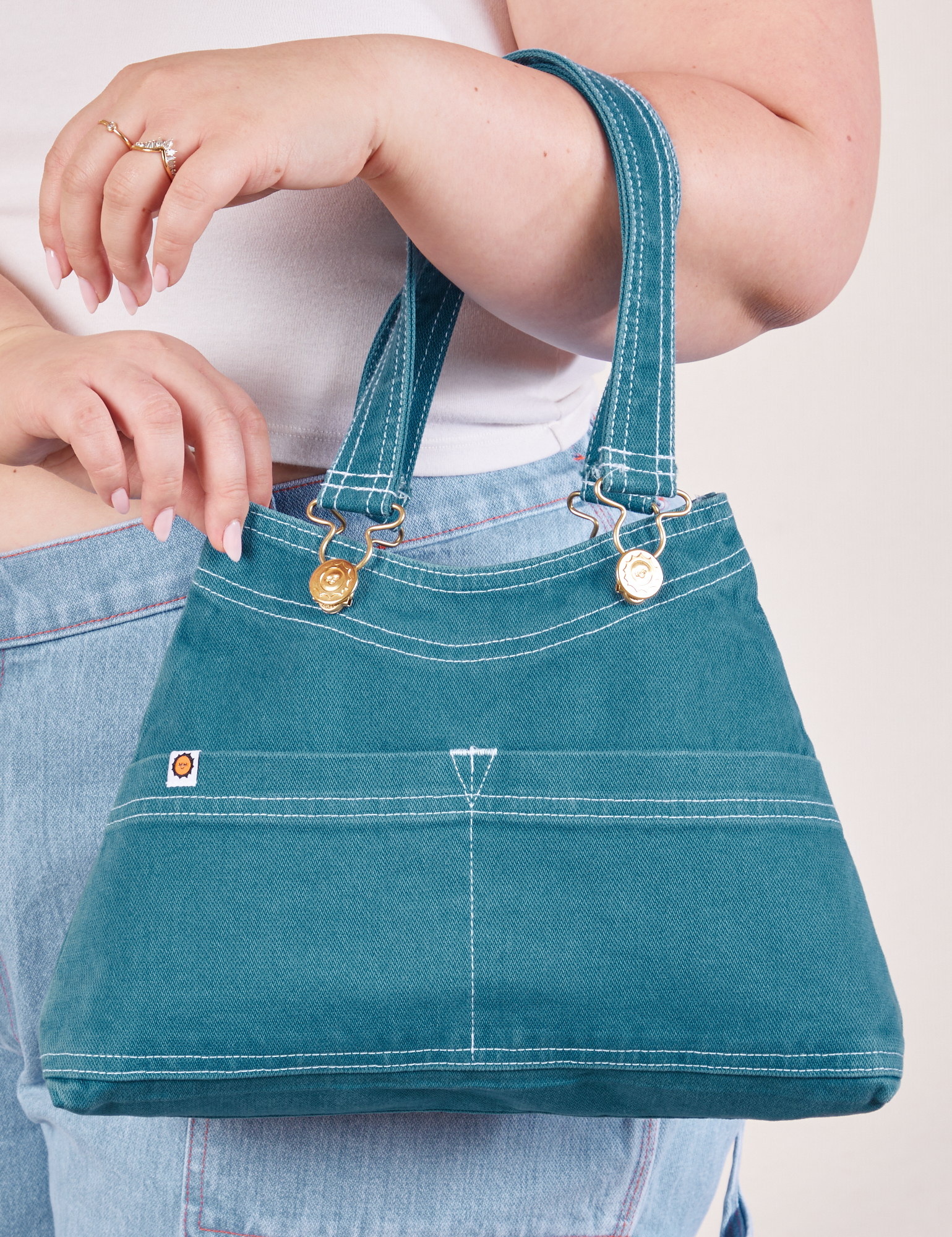 Overall Handbag in Marine Blue on arm of model