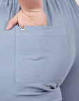 Petite Short Sleeve Jumpsuit in Periwinkle back pocket close up. Ashley has her hand in the pocket.
