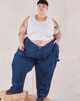 Jordan is 5'4" and wearing 6XL Petite Carpenter Jeans in Dark Wash paired with vintage off-white Tank Top