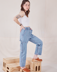 Side view of Petite Carpenter Jeans in Light Wash and vintage off-white Cami on Hana