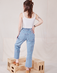 Back view of Petite Carpenter Jeans in Light Wash and vintage off-white Cami on Hana