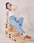 Hana is wearing Petite Carpenter Jeans in Light Wash and vintage off-white Cami