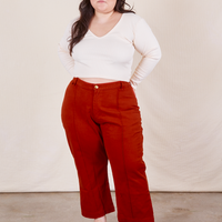 Ashley is 5'7 and wearing 1XL Petite Western Pants in Paprika paired with a vintage off-white Long Sleeve V-Neck Tee