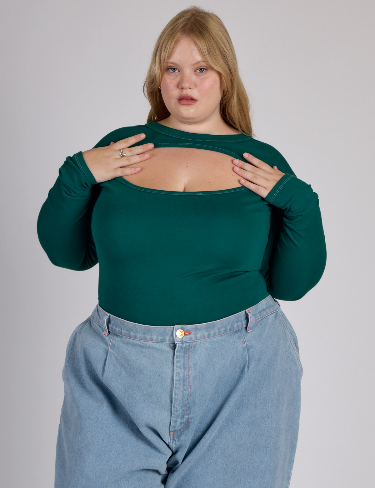 Juliet wearing the Hunter Green Long Sleeve Porthole Tee tucked in