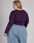 Back view of Juliet in the Nebula Purple Long Sleeve Porthole Tee