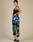 Angled back view of the Rainbow Magic Waters Work Pants on Alex