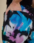 Close up of Alex's hand in the back pocket of the Rainbow Magic Waters Work Pants