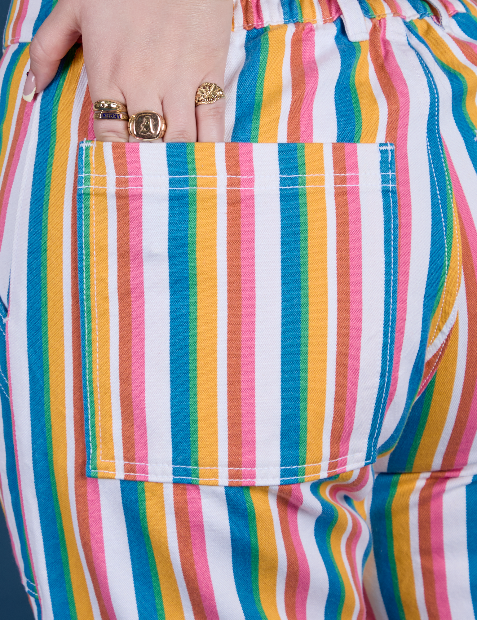 Close up of Sydney's hand in the back pocket of Work Pants in Rainbow Stripe 