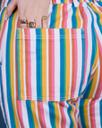 Close up of Sydney's hand in the back pocket of Work Pants in Rainbow Stripe 