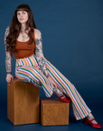 Sydney is wearing Work Pants in Rainbow Stripe and burnt terracotta Cropped Tank
