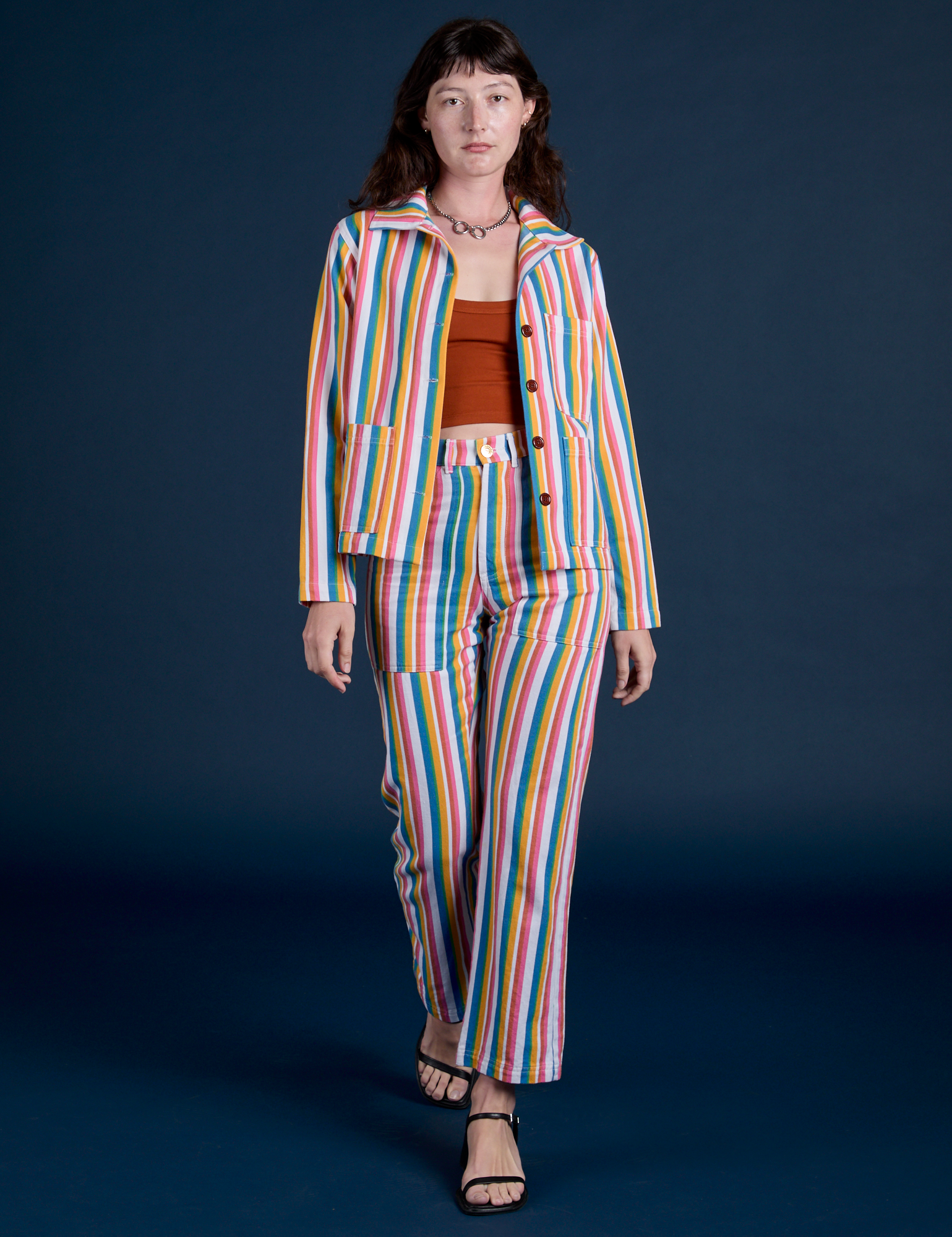 Alex is wearing Work Pants in Rainbow Stripe and matching Work Jacket