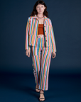 Alex is wearing Work Pants in Rainbow Stripe and matching Work Jacket