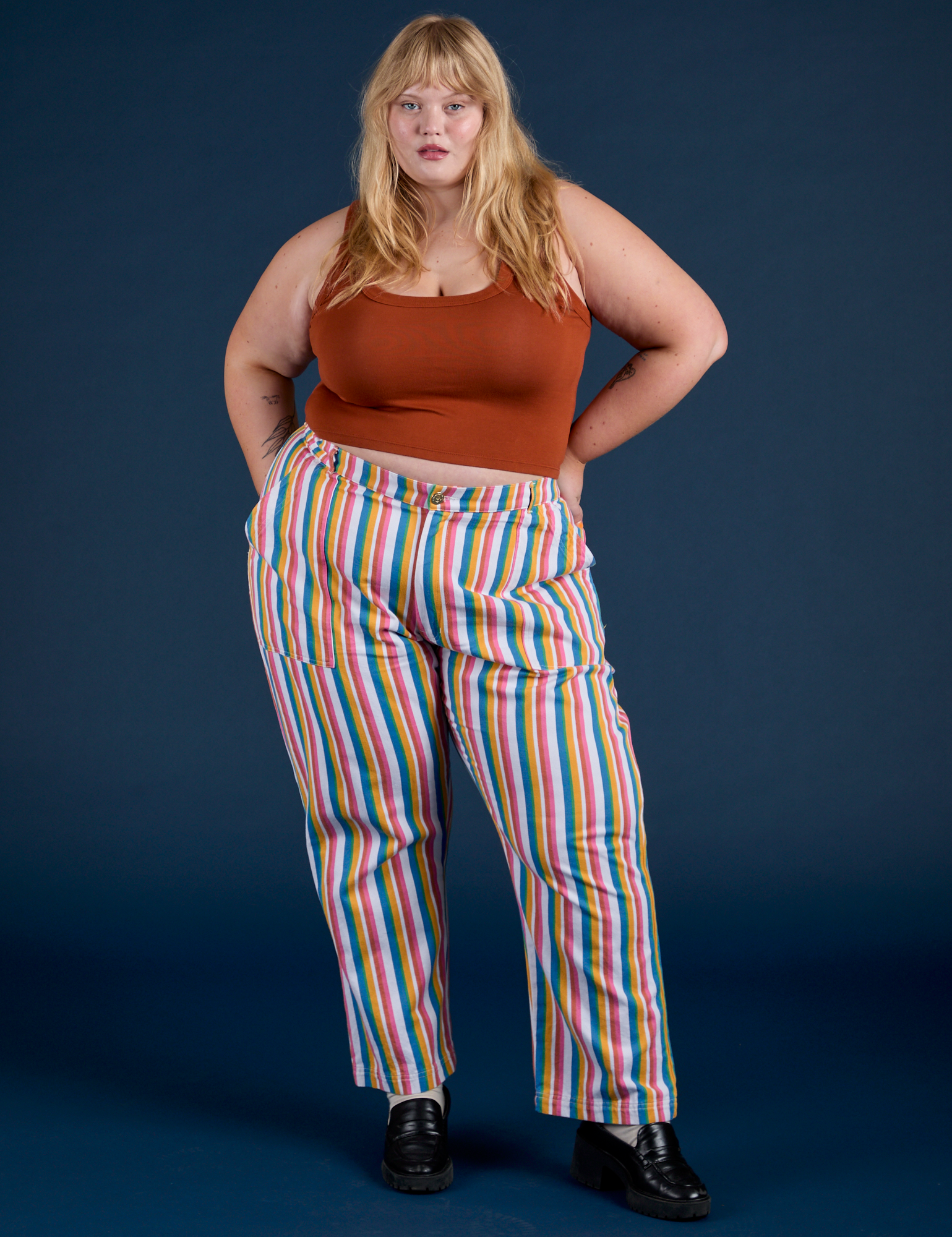 Juliet is 5’7” and wearing 1XL Work Pants in Rainbow Stripe paired with burnt terracotta Cropped Tank