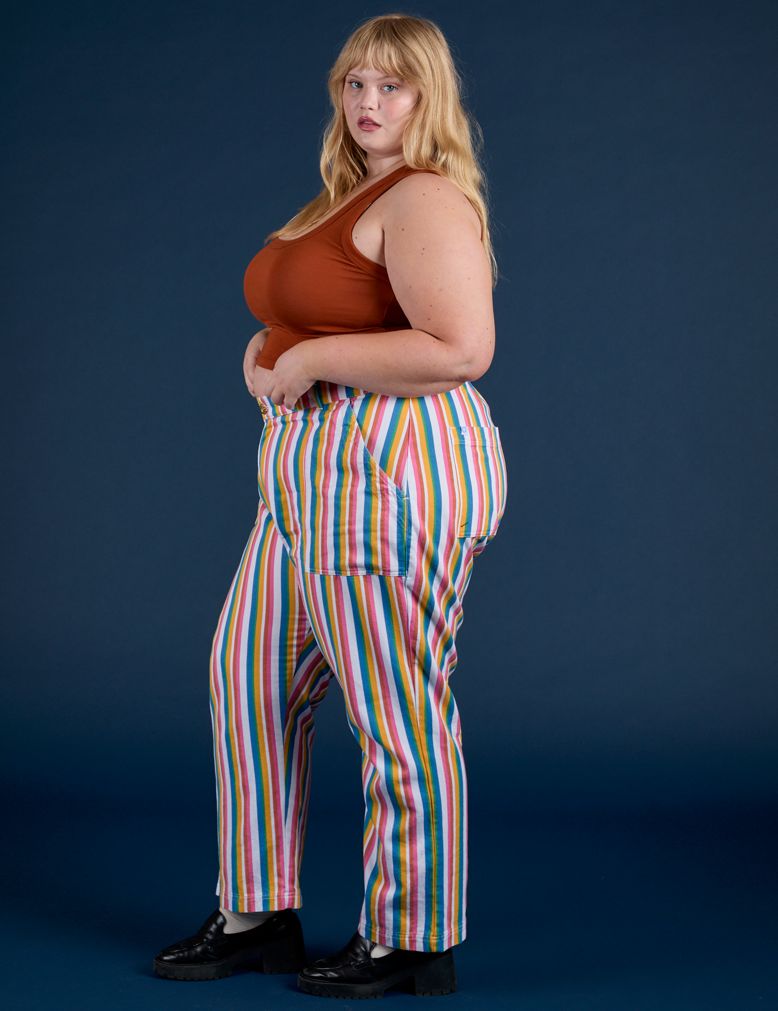 Side view of Work Pants in Rainbow Stripe and burnt terracotta Cropped Tank