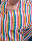 Close up of Juliet's hand in the front pocket of Work Pants in Rainbow Stripe
