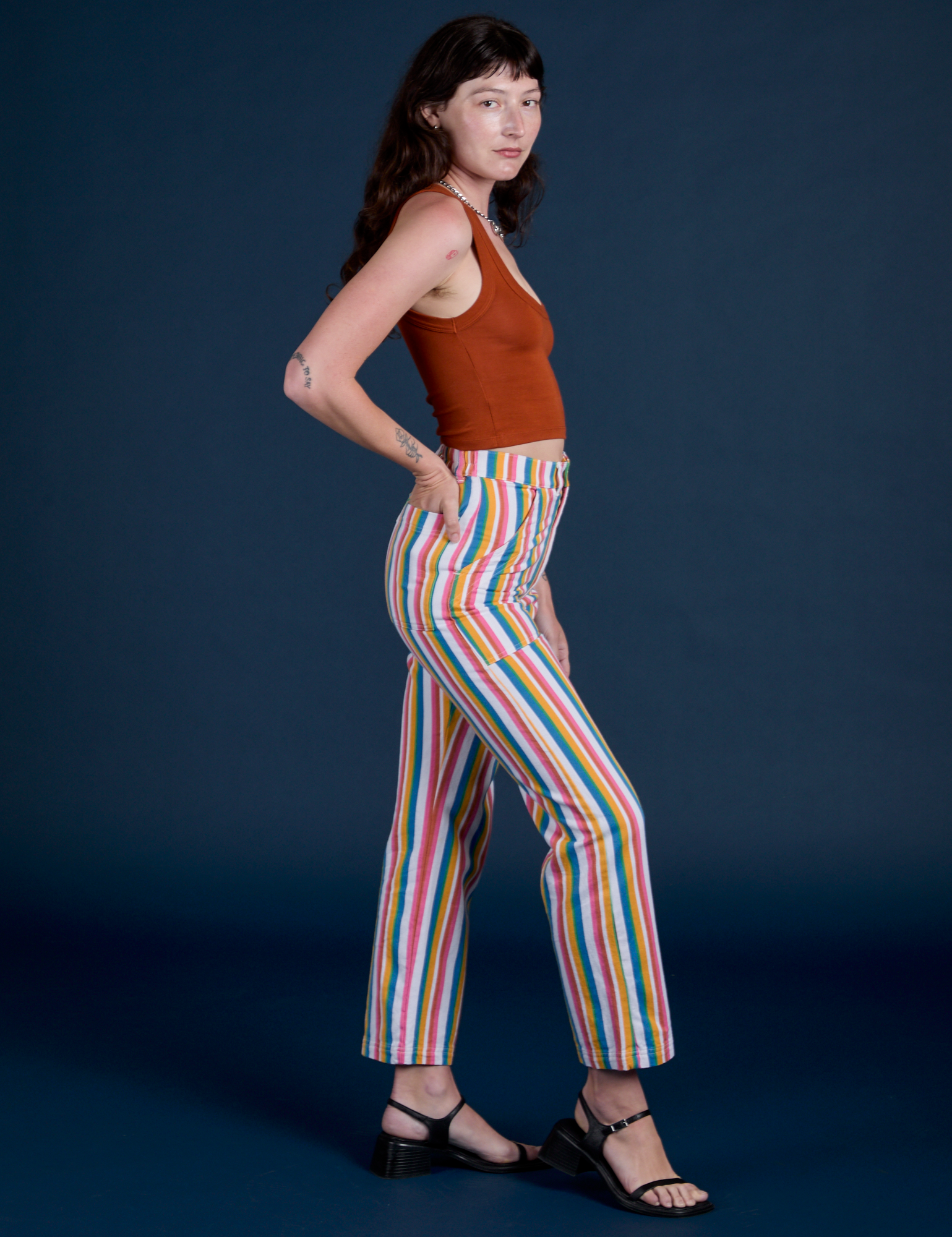 Side view of Work Pants in Rainbow Stripe paired with burnt terracotta Cropped Tank