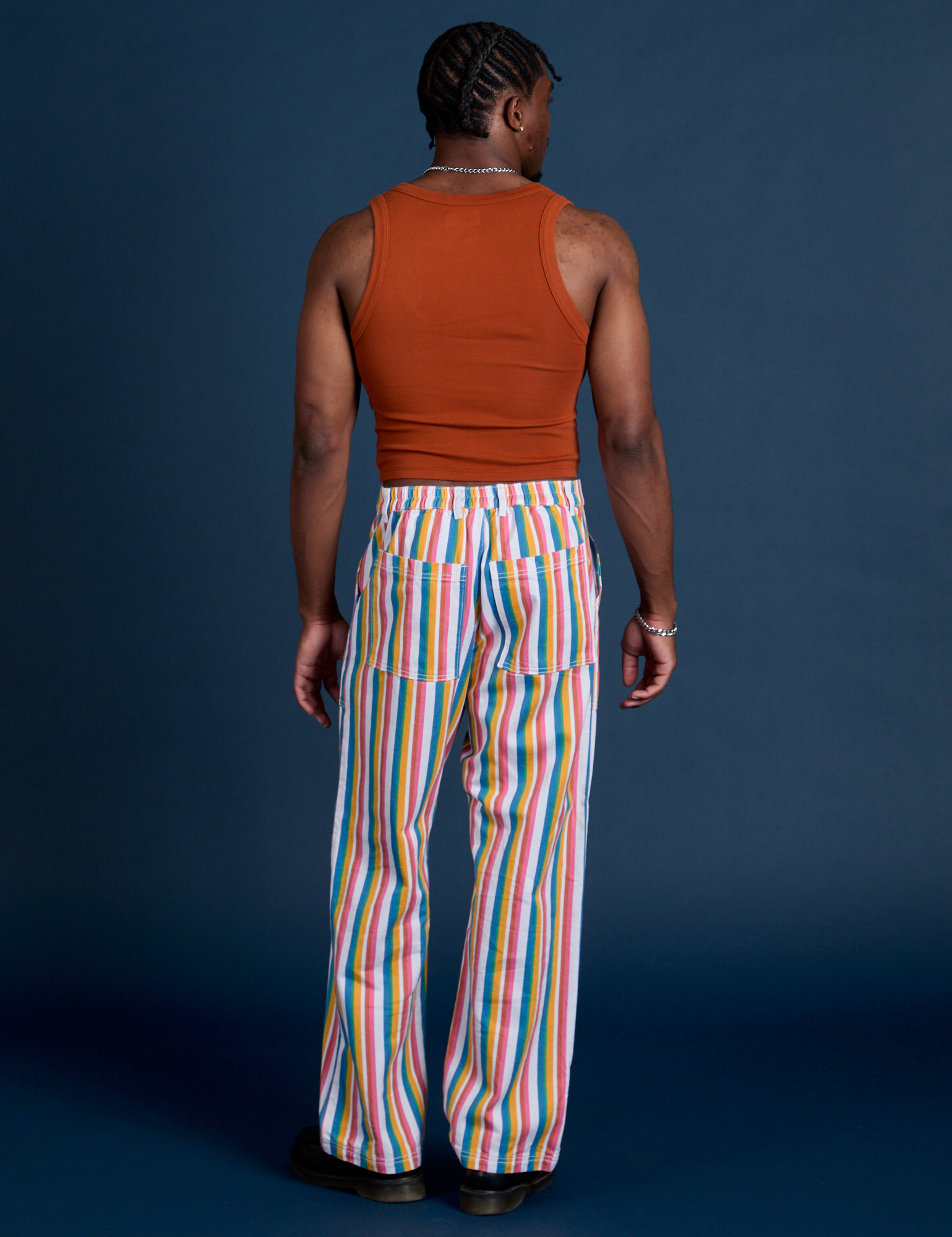 Back view of Work Pants in Rainbow Stripe and burnt terracotta Cropped Tank