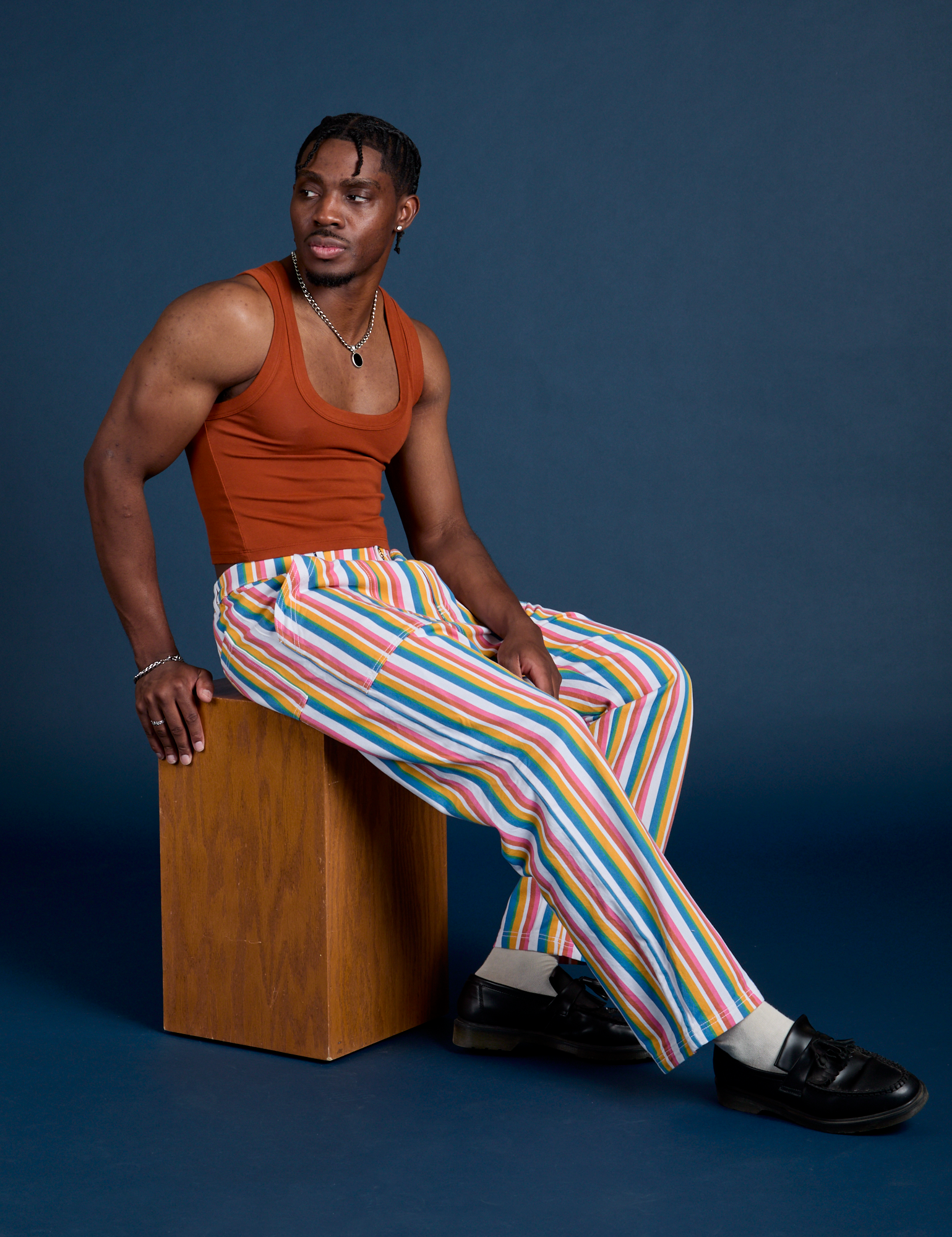 Isaac is 5’10” and wearing M Work Pants in Rainbow Stripe paired with burnt terracotta Cropped Tank