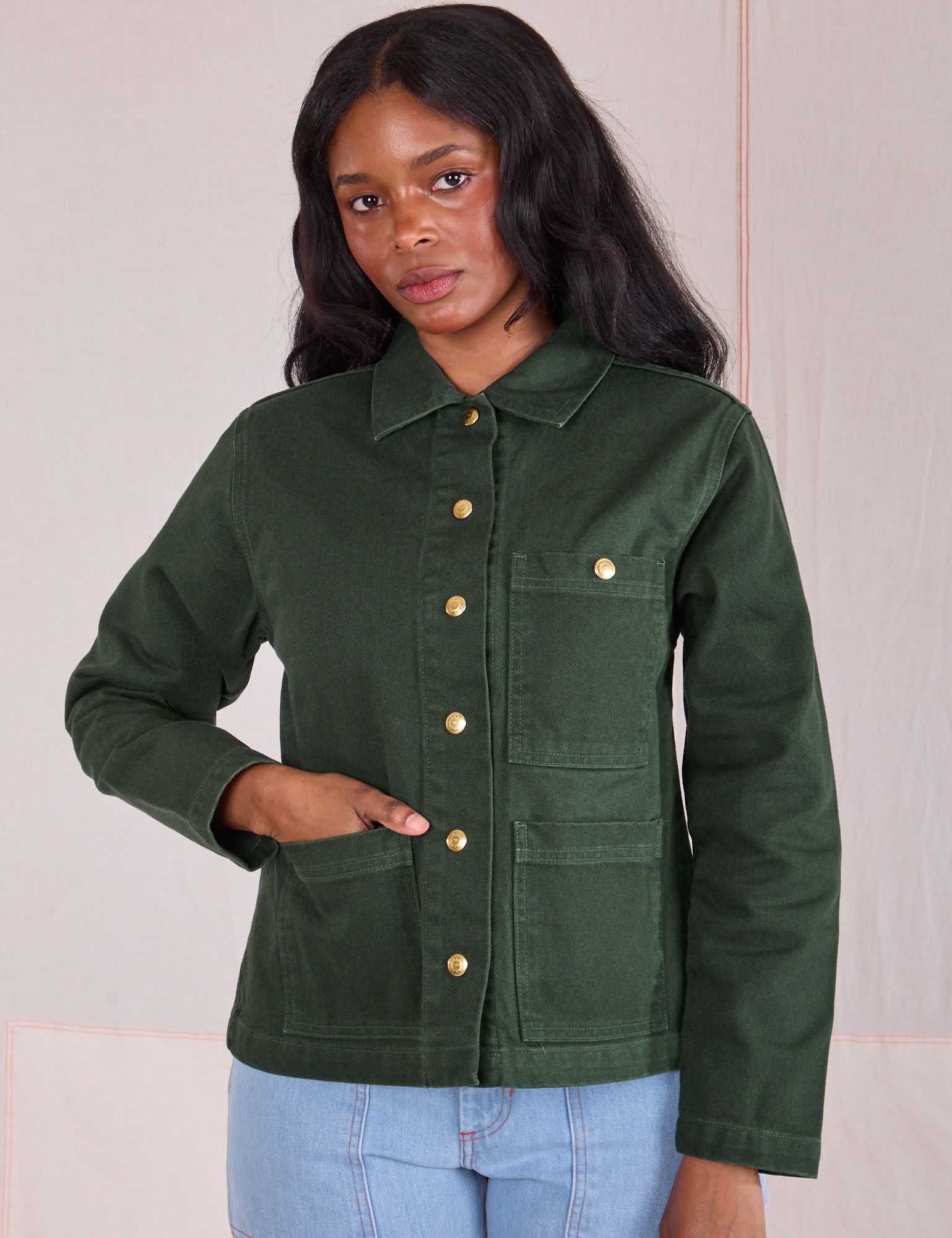 Kandia is wearing a buttoned up Denim Work Jacket in Swamp Green