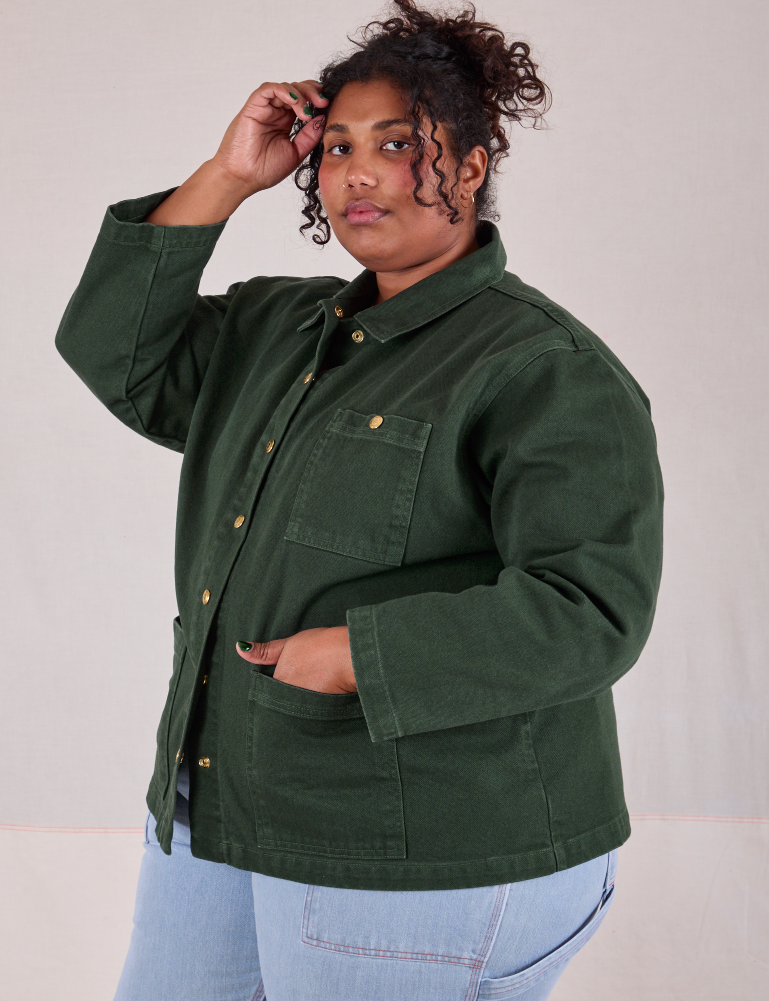 Morgan is wearing a buttoned up Denim Work Jacket in Swamp Green