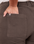 Classic Work Shorts in Espresso Brown back pocket close up. Morgan has her hand in the pocket.