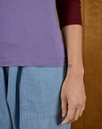 Close up of the hem on the Faded Grape/Wine Colorblock Raglan Tee worn by Alex