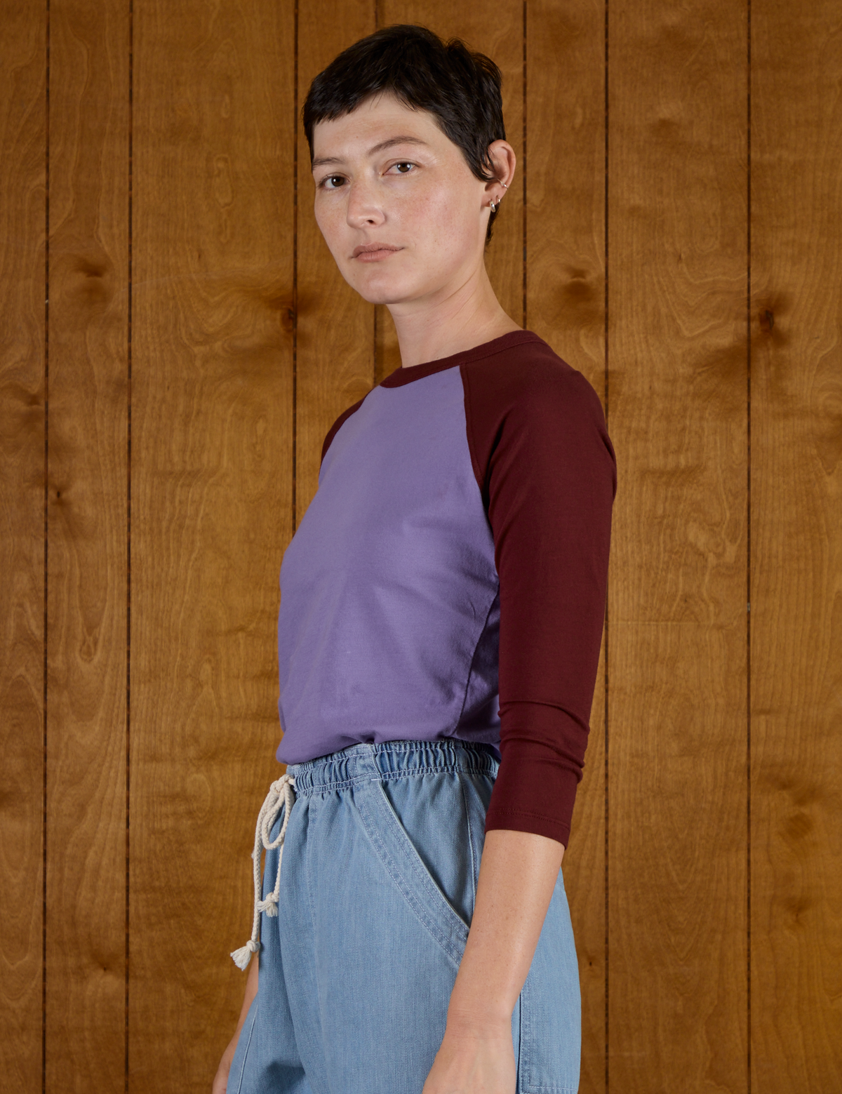 Side view of the Faded Grape/Wine Colorblock Raglan Tee on Alex
