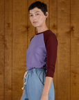Side view of the Faded Grape/Wine Colorblock Raglan Tee on Alex