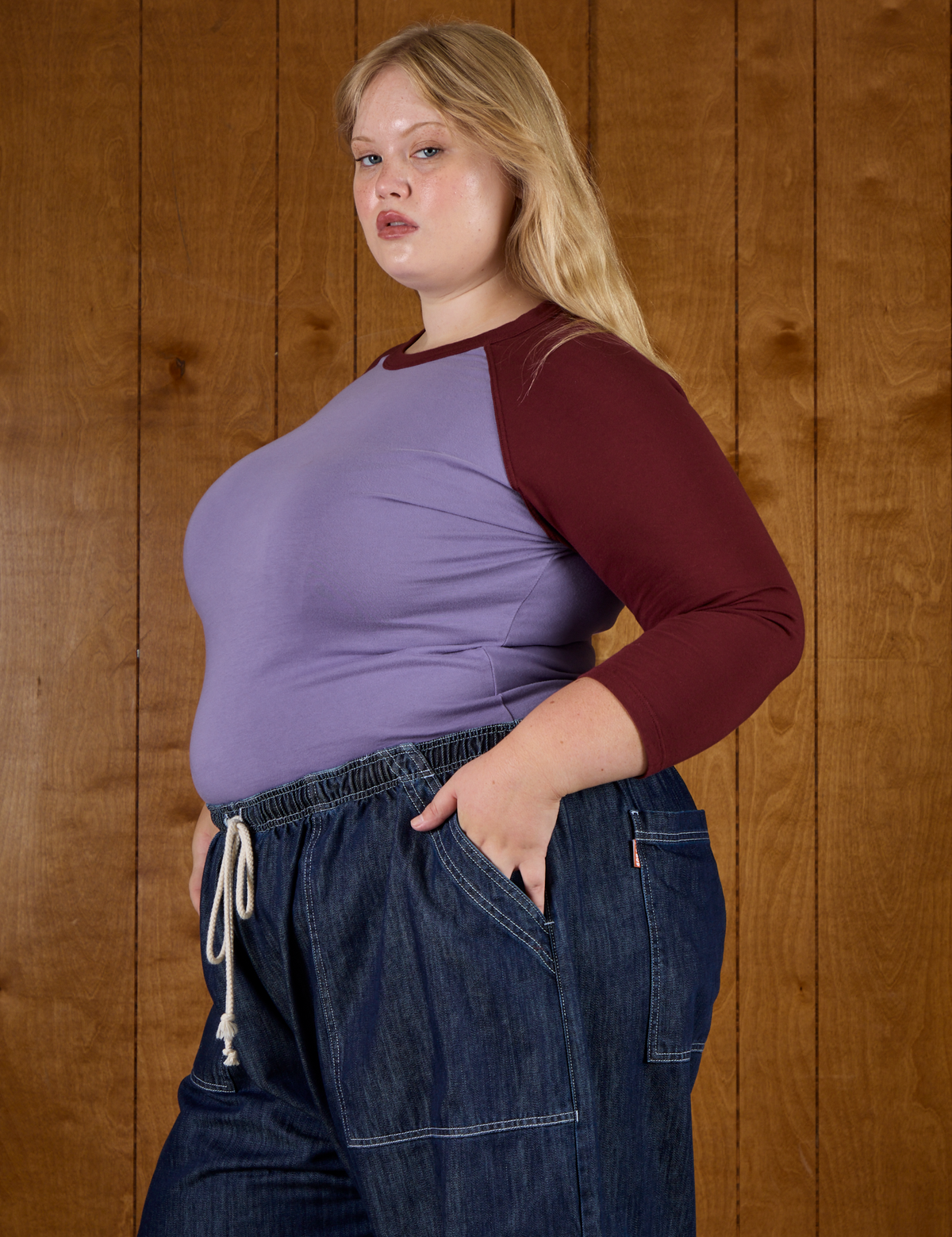 Side view of Juliet wearing the Faded Grape/Wine Colorblock Raglan Tee