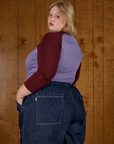 Angled back view of Juliet in the Faded Grape/Wine Colorblock Raglan Tee