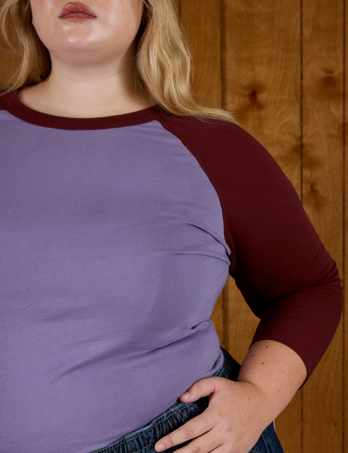 Close up of the Faded Grape/Wine Colorblock Raglan Tee's sleeve on Juliet