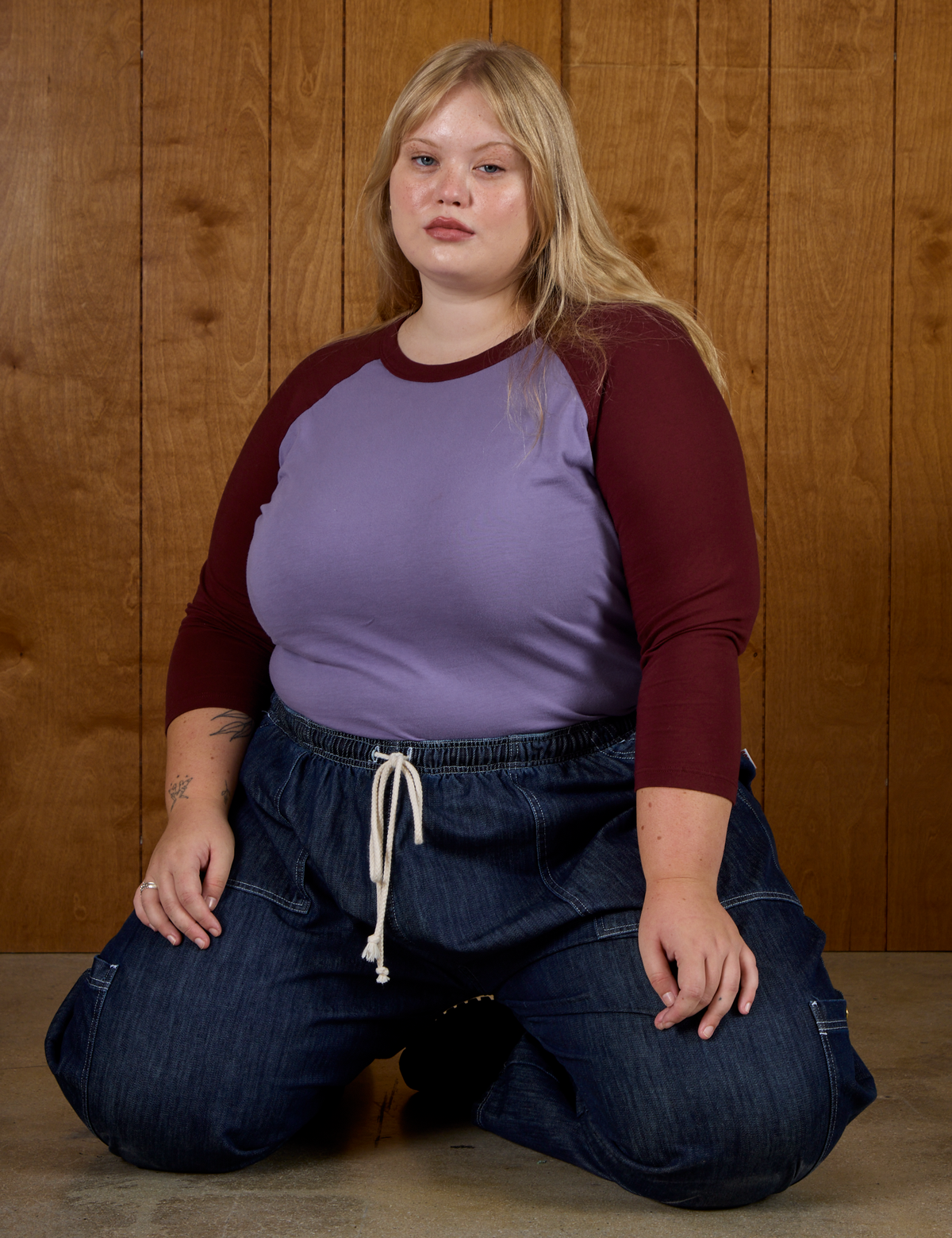 Juliet wearing the Faded Grape/Wine Colorblock Raglan Tee tucked into the Dark Wash Denim Drop Pocket Pants