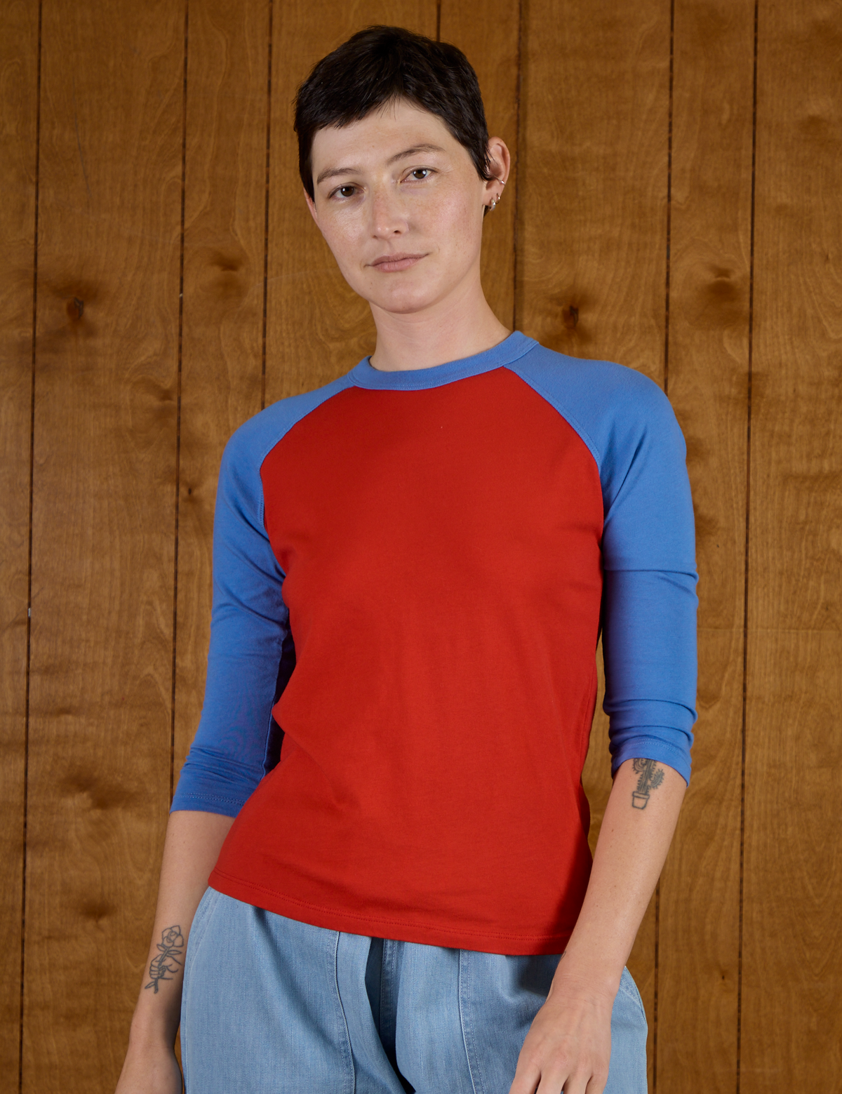 Alex is 5'8" and wearing P Mustang Red/Blue Colorblock Raglan Tee