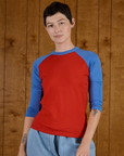 Alex is 5'8" and wearing P Mustang Red/Blue Colorblock Raglan Tee