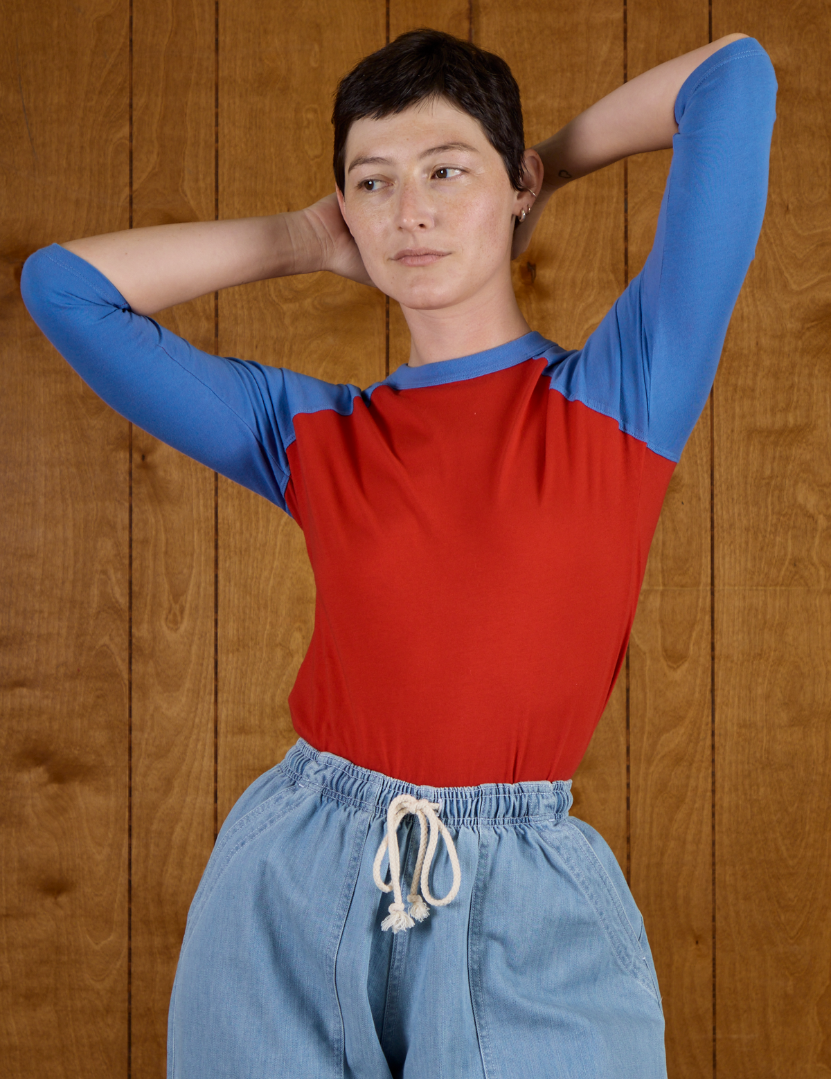 Alex wearing the Mustang Red/Blue Colorblock Raglan Tee tucked into the Light Wash Drop Pocket Pants