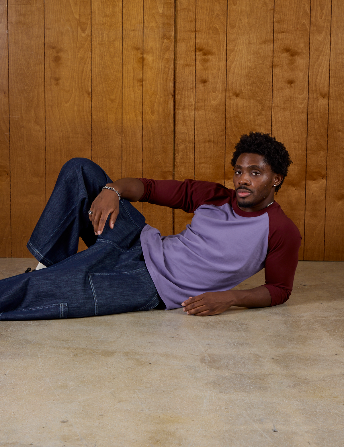 Isaac wearing the Faded Grape/Wine Colorblock Raglan Tee with Dark Wash Denim Drop Pocket Pants
