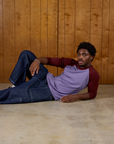 Isaac wearing the Faded Grape/Wine Colorblock Raglan Tee with Dark Wash Denim Drop Pocket Pants