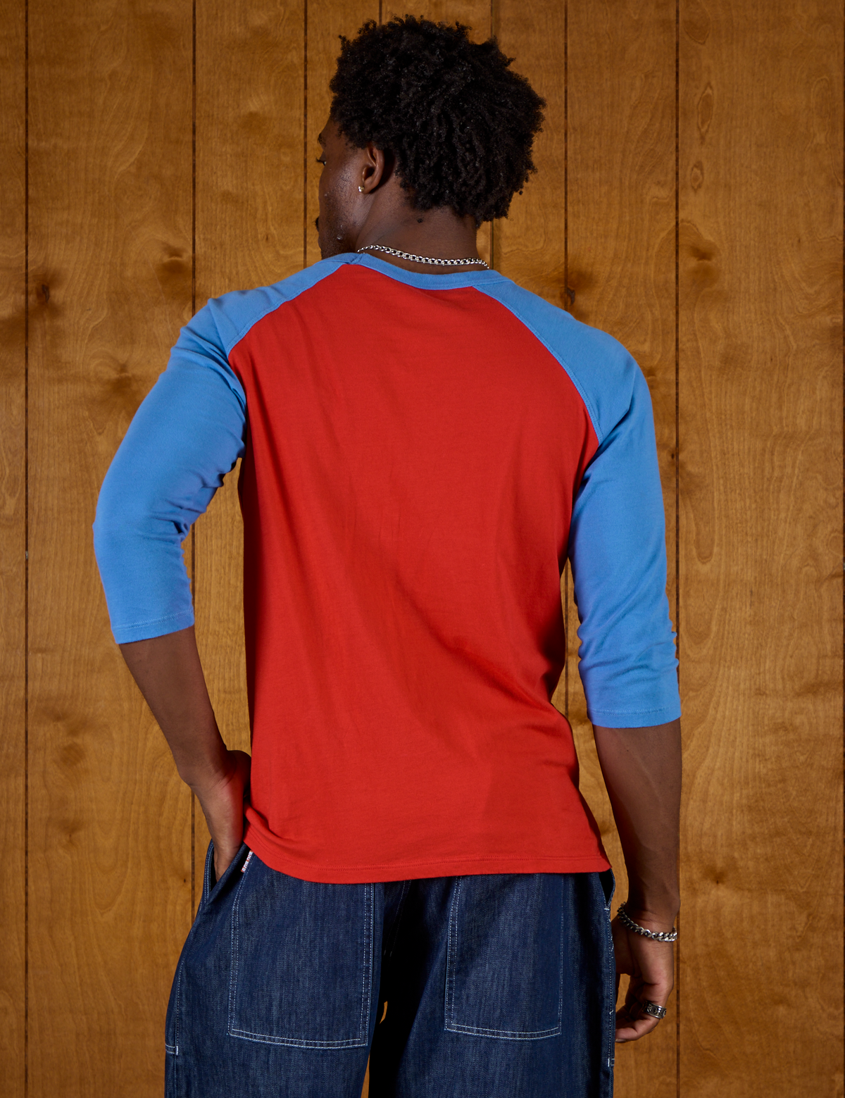 Back view of the Mustang Red/Blue Colorblock Raglan Tee on Isaac