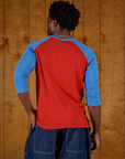 Back view of the Mustang Red/Blue Colorblock Raglan Tee on Isaac