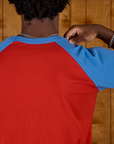 Close up back view of the Mustang Red/Blue Colorblock Raglan Tee on Isaac