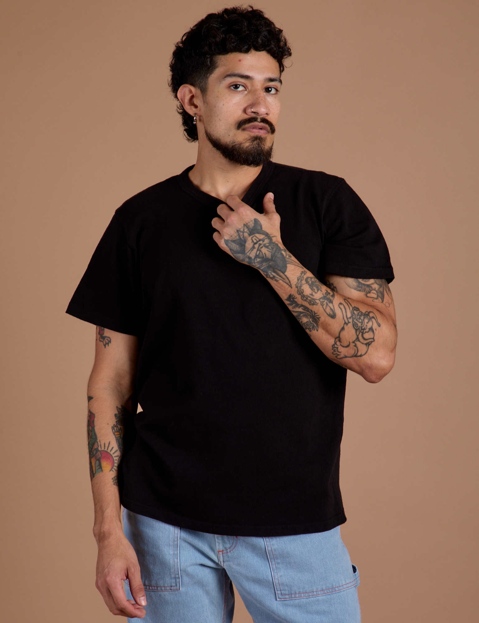 Jesse is wearing Burly Tee in Basic Black