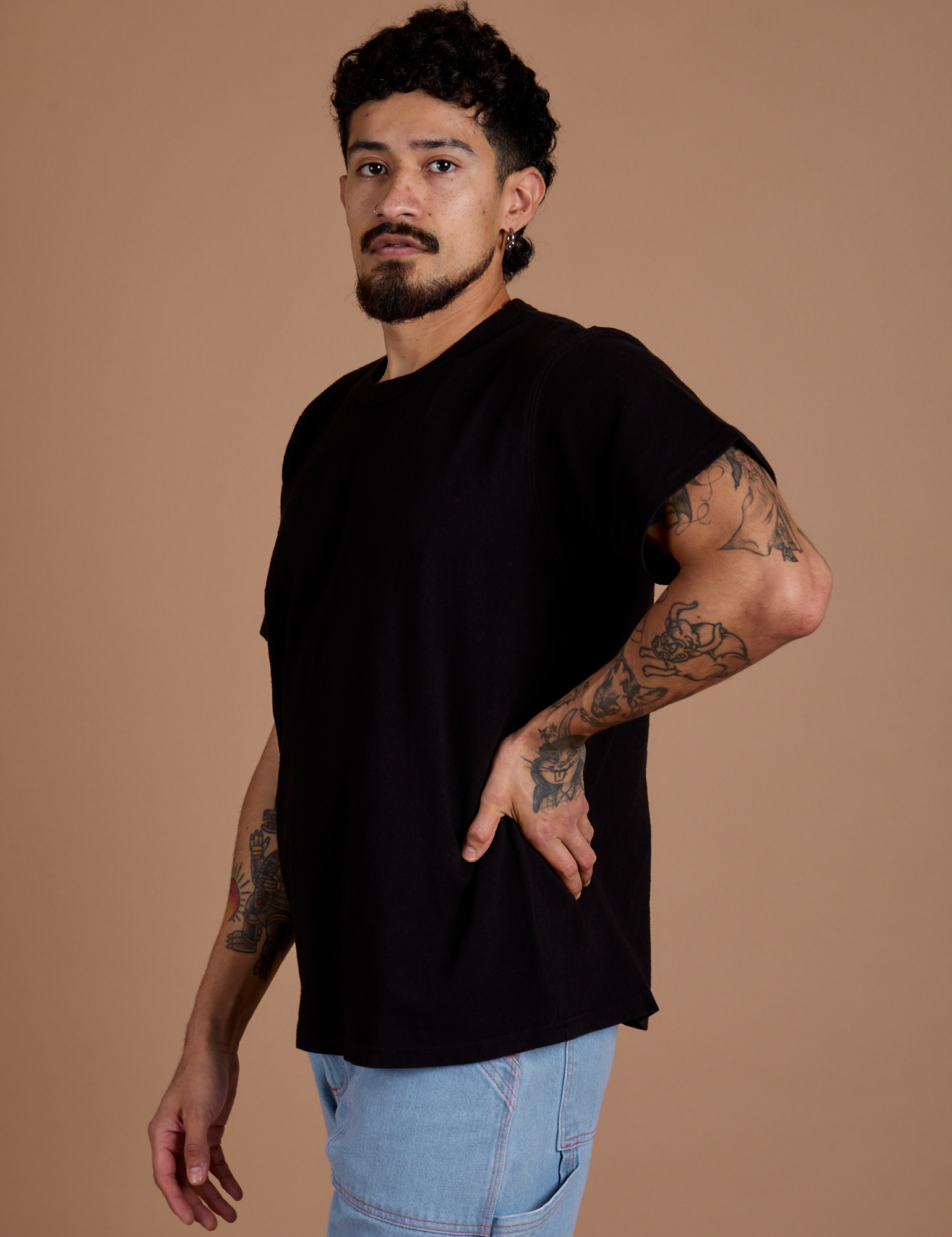 Angled front view of Burly Tee in Basic Black on Jesse
