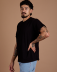 Angled front view of Burly Tee in Basic Black on Jesse