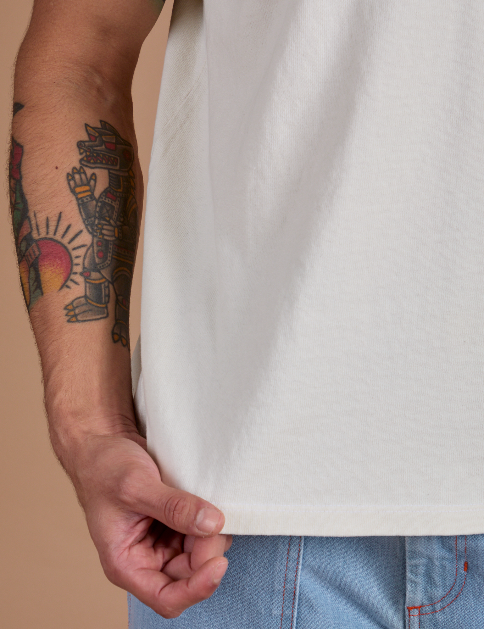 Burly Tee in Vintage Tee White bottom hem close up on Jesse