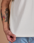 Burly Tee in Vintage Tee White bottom hem close up on Jesse