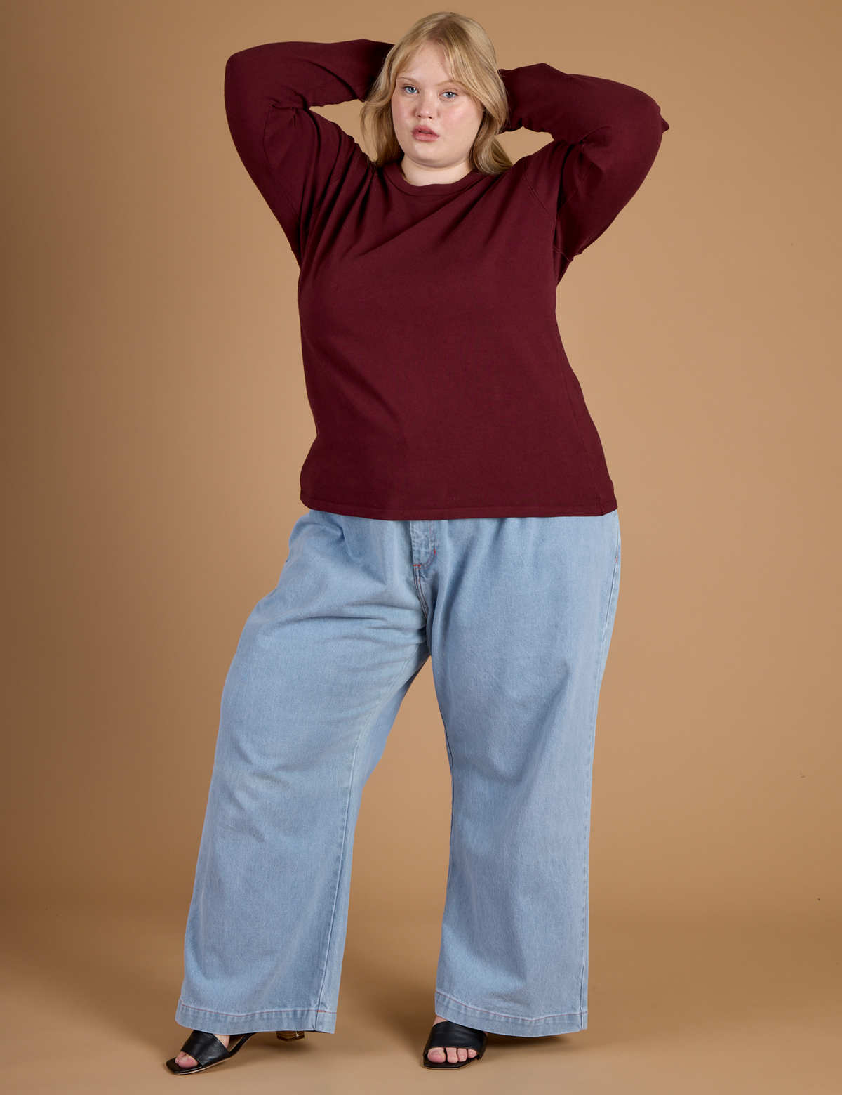 Juliet is 5'7" and wearing the Red Wine Long Sleeve Burly Tee with the Light Wash Wide Leg Denim Trousers